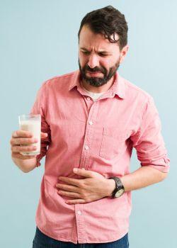Man Having Stomach Discomfort After Drinking a Protein Shake